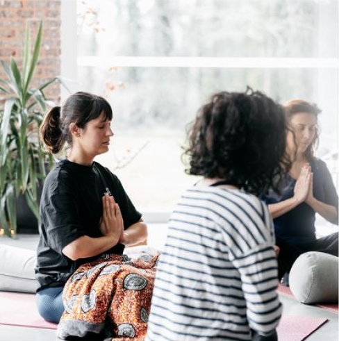 Photo d’une personne pratiquant le yoga dans une posture de méditation, en plein air ou en studio.